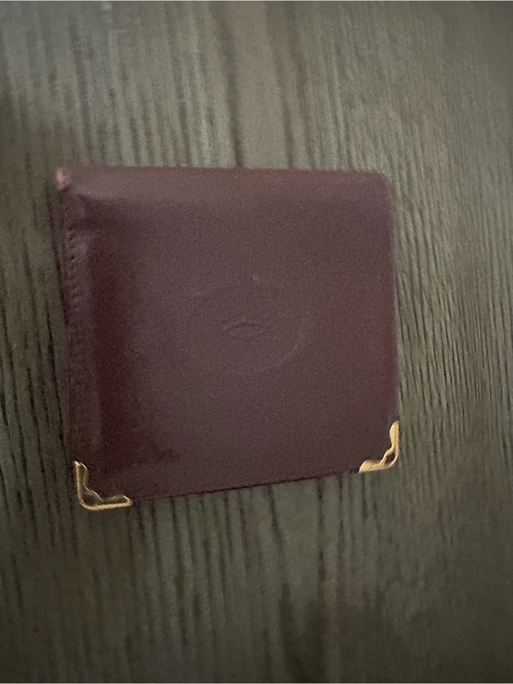 Cartier burgundy leather card case with gold corner detail